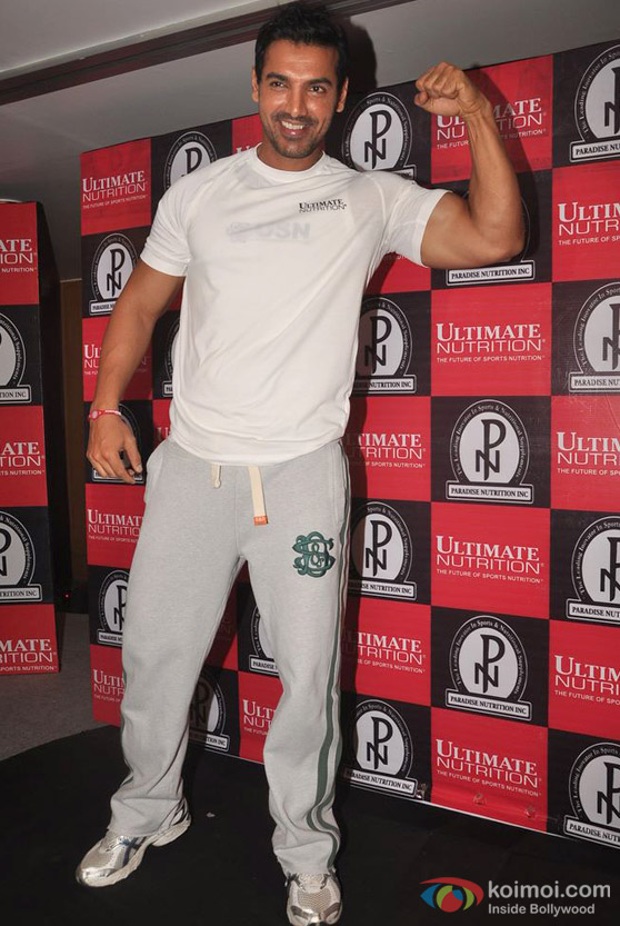John Abraham flexes his biceps