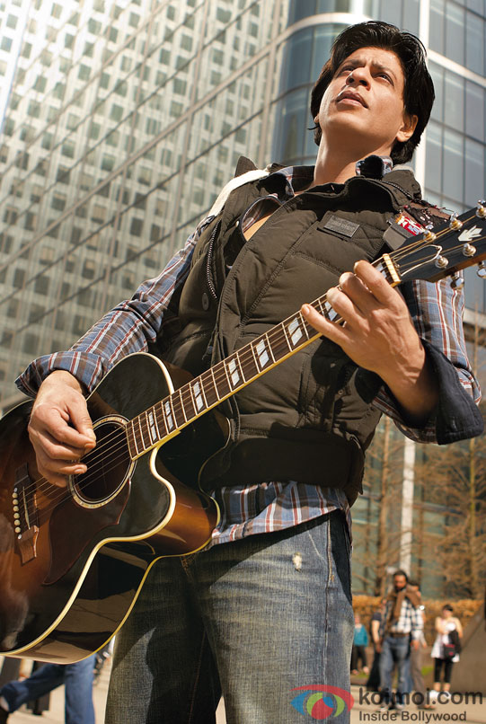 Shah Rukh Khan playing a guitar
