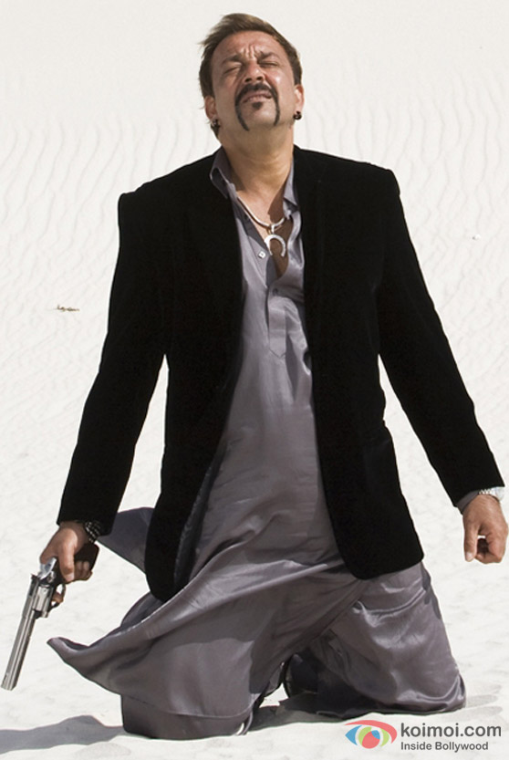 Sanjay Dutt kneels in the sand in Luck Movie