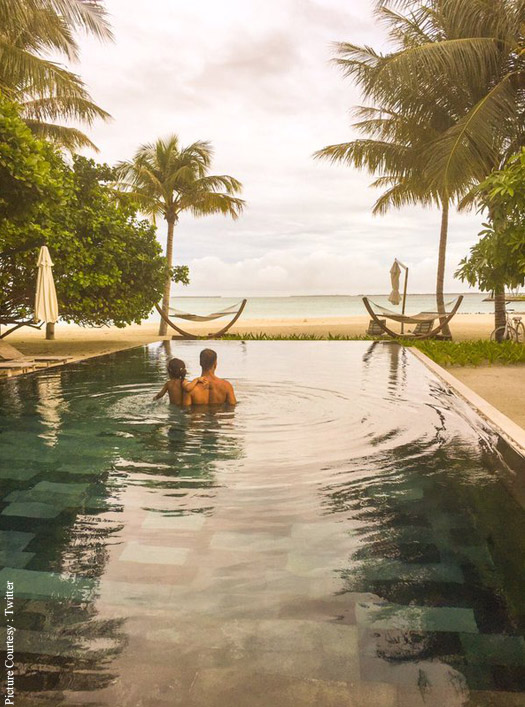 Alkshay Kumar and Nitara standing inside a pool looking at the beach