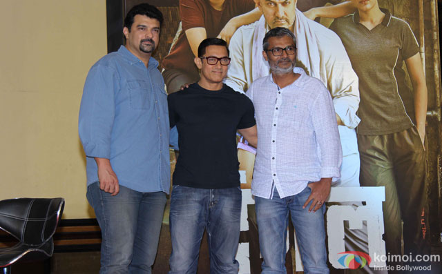 Siddharth Roy Kapur, Aamir Khan and Nitesh Tiwari during the poster launch of film 'Dangal'