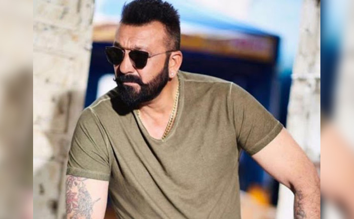 Sixpack abs pony tail and a tattoo Sanjay Dutt walks out of jail in  style  India Today