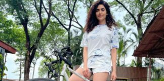 Karishma strikes a pose with her bike