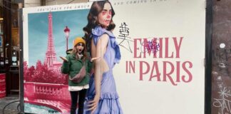 Lily Collins Gives A Jolly & Playful Comeback To Haters By Posing In Front Of A Vandalised Promotional Poster Of Emily In Paris, Check It Out