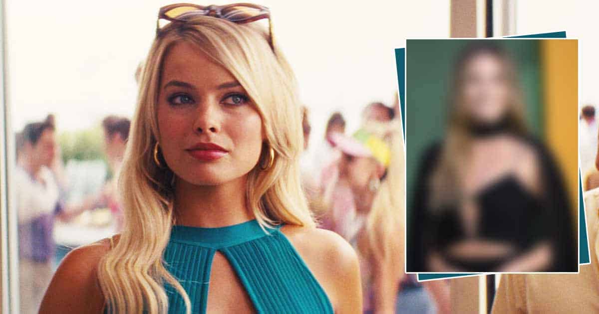 Margot Robbie Keeps It Simple Yet Elegant In A Black Gown With A Cape, & A Delicate Slit