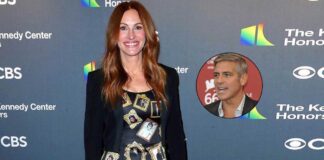 Julia Roberts wears a gown with George Clooney's framed pictures