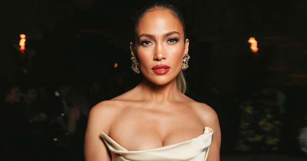 Jennifer Lopez Turns Up The Heat In An Ivory Semi-Sheer Dress With Interesting Patterns & Gives A Glimpse Of Her Lace Garter