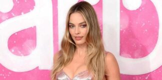 Margot Robbie Shells Out Boss Lady Vibes As She Slips Into An All-Black Ensemble With Strapless Corset & Baggy Pants