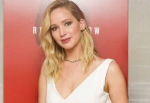 Jennifer Lawrence is smiling on a red carpet, reflecting on her decision to turn down the role of Alice in Wonderland.
