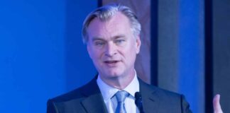 Why does Christopher Nolan have a strict no-phone policy while shooting?
