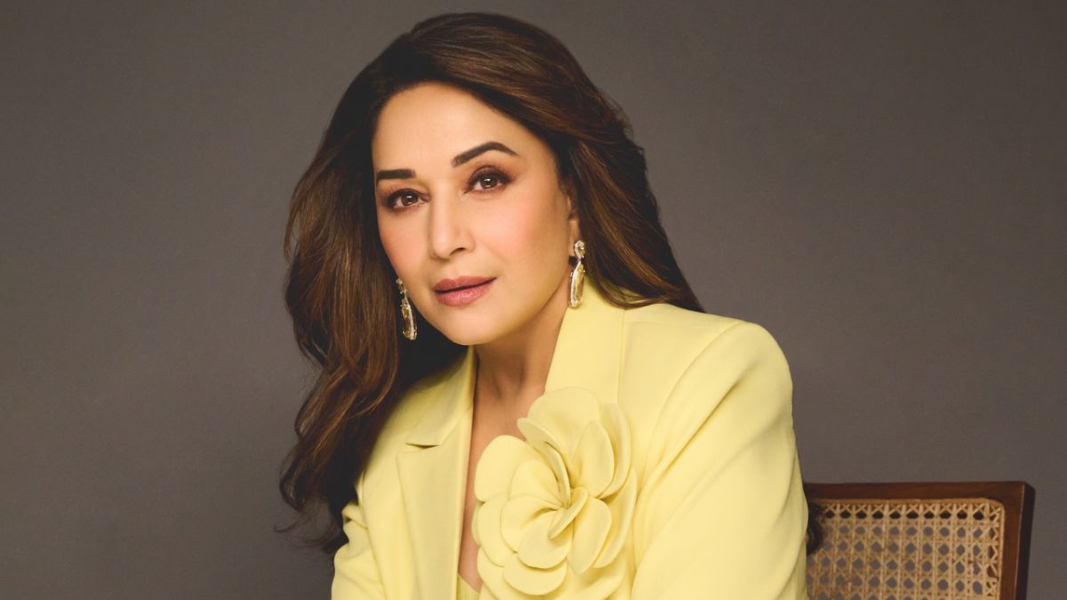 Madhuri Dixit in an embellished rose gold and white outfit, posing for a studio photo